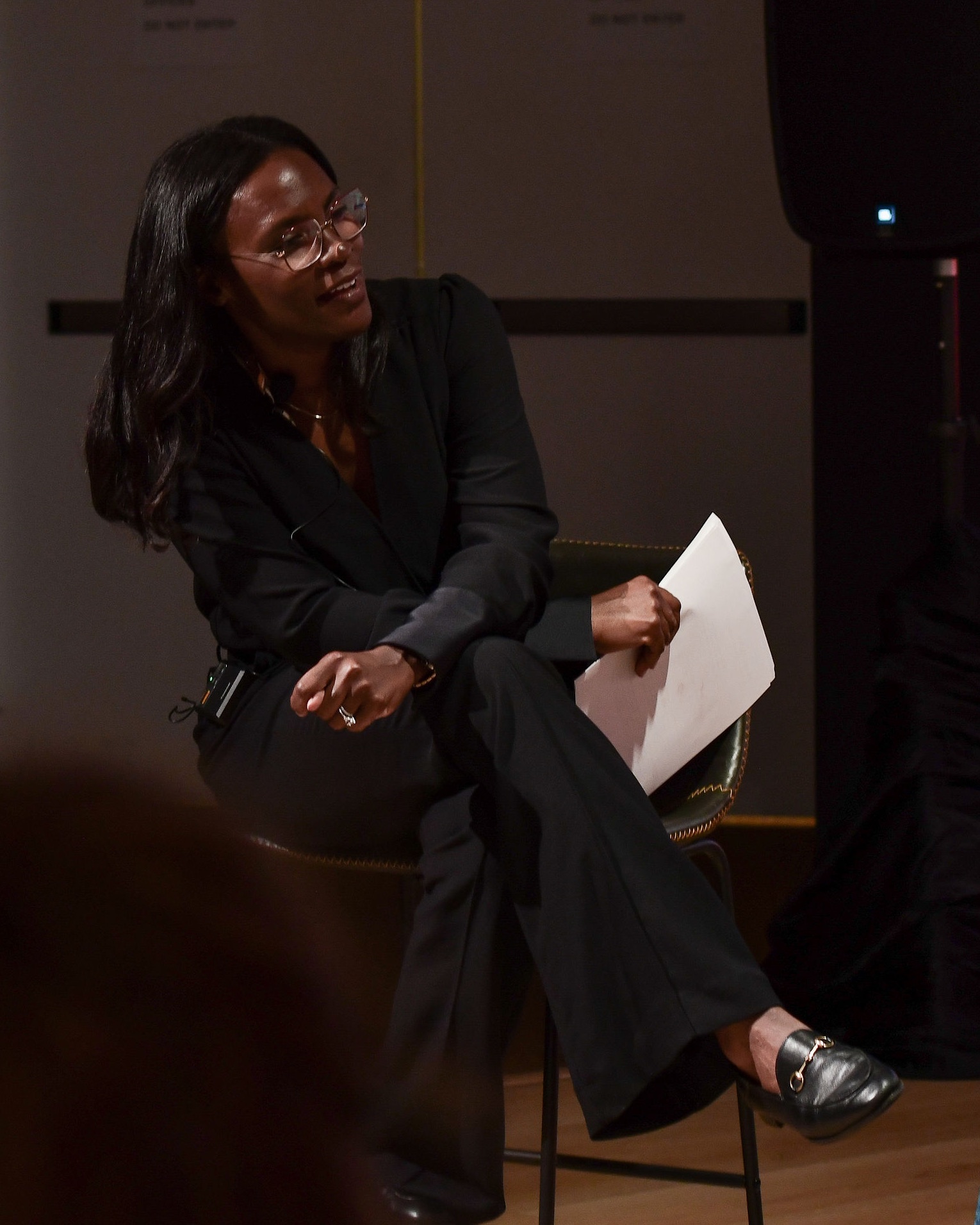 Kali Fields Williams speaking on stage at the Museum of the African Diaspora
